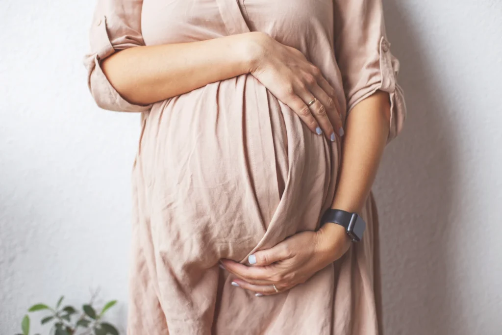 pregnant-woman-s-belly-closeup-hands-hugging-bell-2022-10-11-19-51-50-utc